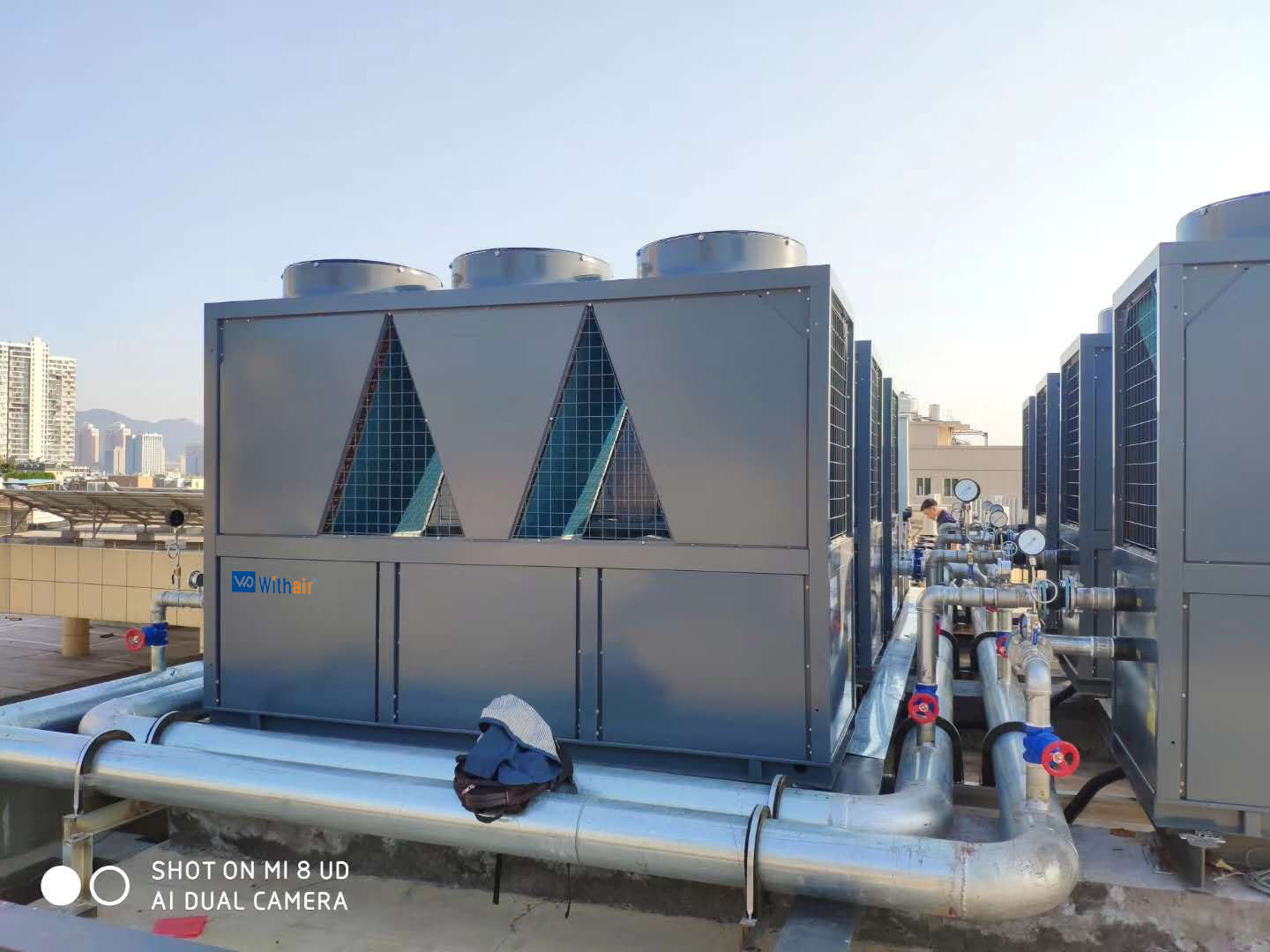 More efficient means of generating hot water through the application of air-cooled chiller systems with heat reclaim capabilities to reduce the energy consumption in buildings.